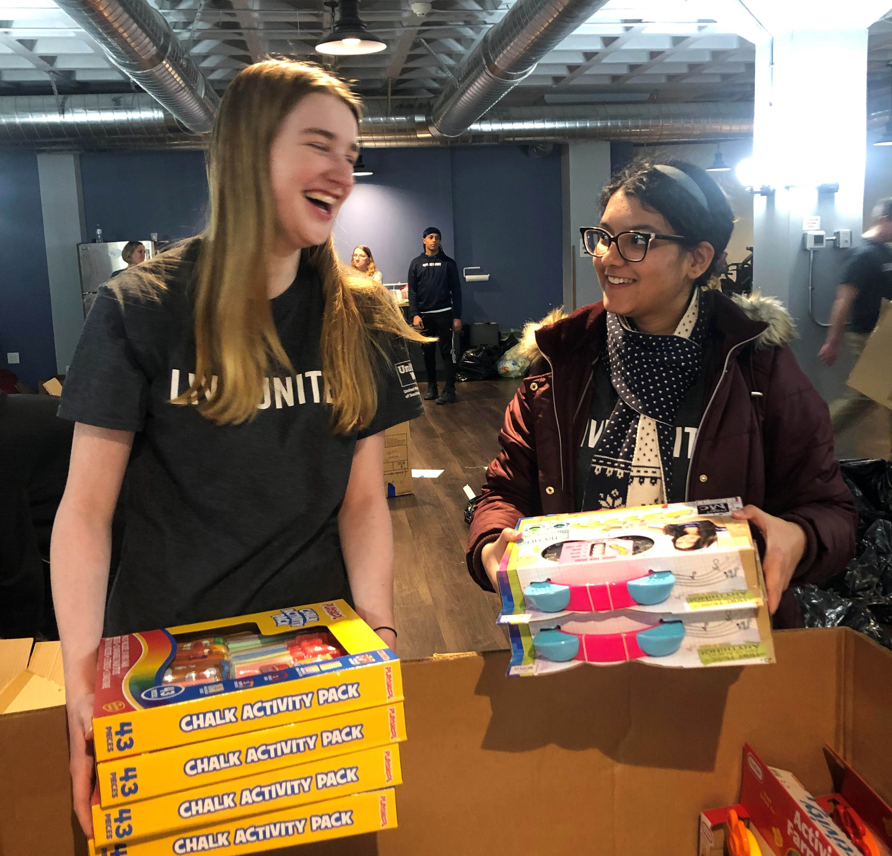Two Student United Way participants volunteer at the Tommy Toy Fund