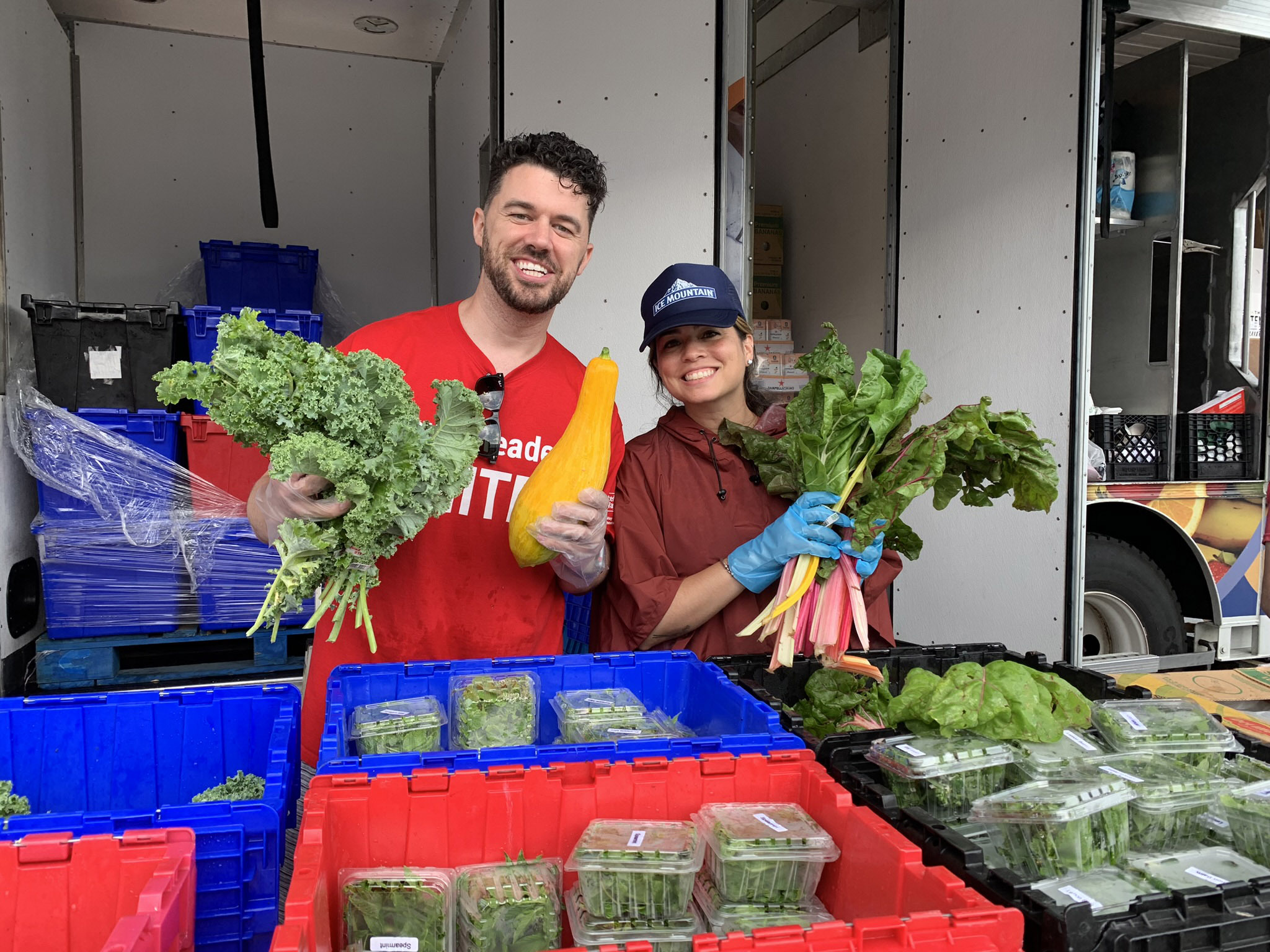 Young Leaders holding fresh vegetables at a Mobile Pantry