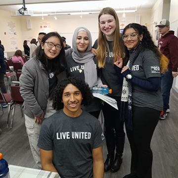 Five students at the Closing Celebration event for Student United Way wearing Live United t-shirts