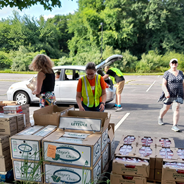 Volunteers handing out food at a mobile pantry