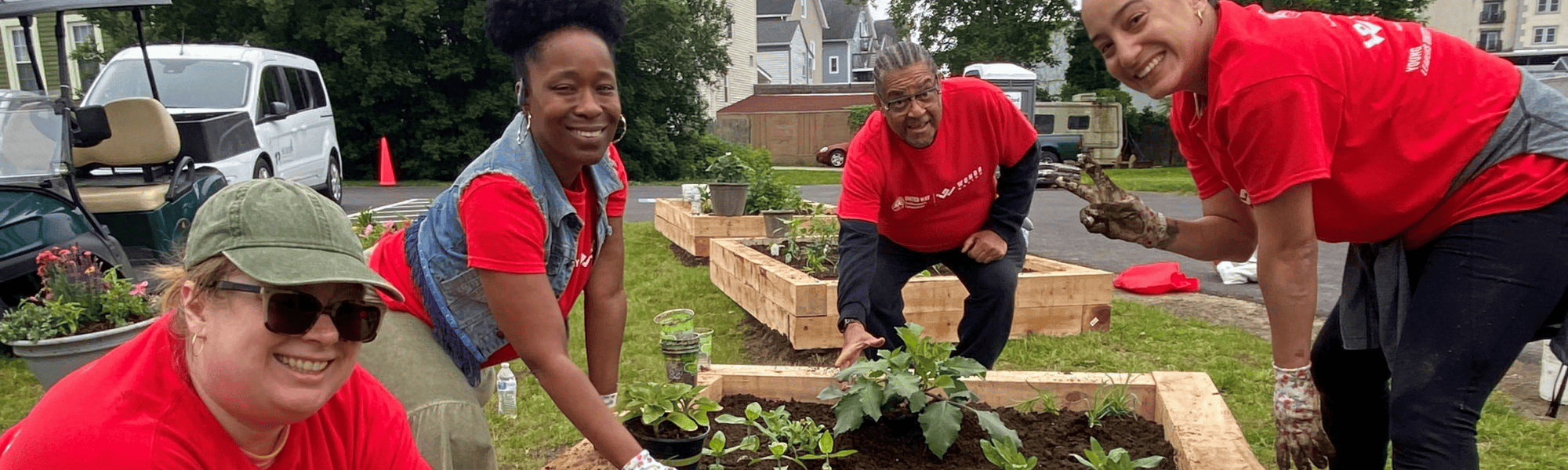 Volunteers planting a raised garden bed