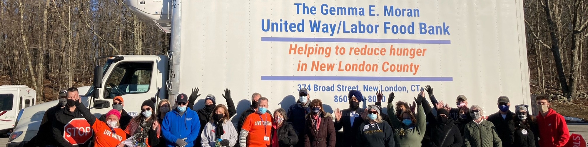 Volunteers at a Mobile Pantry distribution in front of one of the Food Center trucks