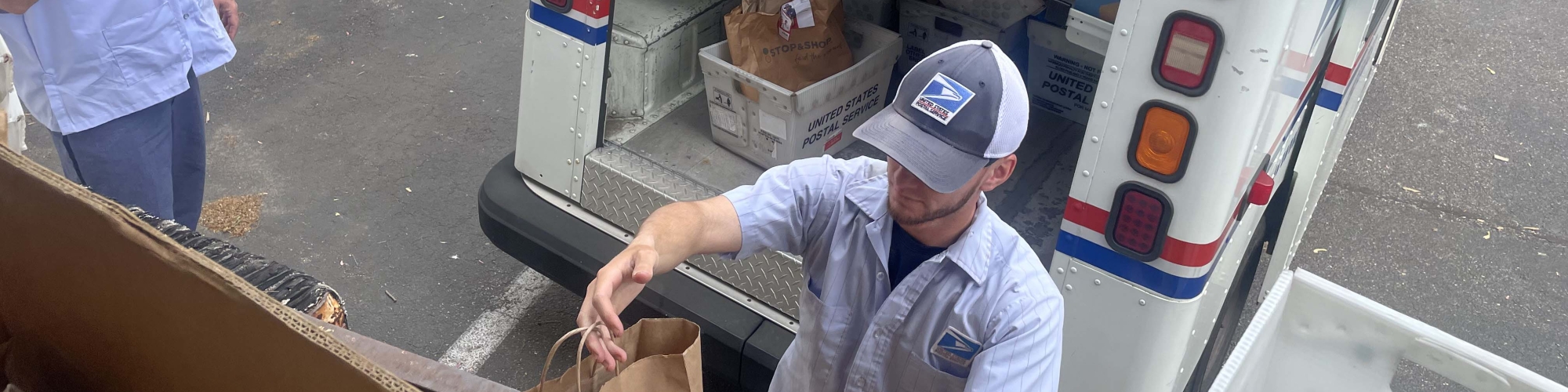 Letter carriers delivering food donations to the Food Center
